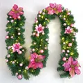 Close-up of 2.7m Christmas garland with pink poinsettia flowers and warm LED lights - Premium Pre-lit Style / Pink