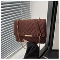 Detail of red-brown suede shoulder bag with V-shaped quilting and gold chain strap - Coffee