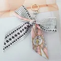 Detail of silk camellia bow keychain with star heart patterns and gold metal ring - No.13 (Pink Bee)