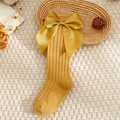 Detail of baby knee high socks in ginger yellow cotton knit with large satin bow - XS (0-1 Years) / Ginger Yellow