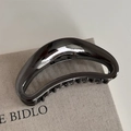 Macro detail of gun black metal hair claw clip with mirror finish and hollow crescent design - Mirror Polishing / Gunmetal