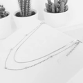 Double layered silver snake chain necklace with beads on a white minimalist pedestal - Round Snake Chain Silver