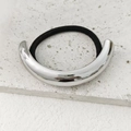 Minimalist silver curved metal hair tie with high-stretch black elastic band on stone - Silver