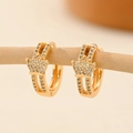 Macro view of gold hoop earrings with crown design and sparkling pavé zircon stones - EH236 Crown Hollow Shape