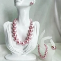 Elegant pink pearl jewelry set featuring necklace, bracelet, earrings and ring on mannequin - Pink