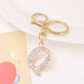 Close-up of golden letter Q keychain with sparkling rhinestones and lobster clasp - Letter Q