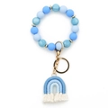 Blue silicone beaded keychain bracelet featuring a woven rainbow tassel and gold ring - Blue