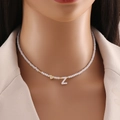 White beaded choker necklace featuring a gold heart and letter Z shell pendant charm - Letter Z