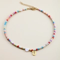 Detail of colorful beaded necklace with white heart charm and gold letter U pendant - Letter U