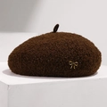 Detail of coffee brown wool beret featuring fluffy texture and a golden bow accent - Adjustable / Brown