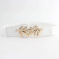 Detail of white elastic waist belt featuring a polished golden metal leaf buckle - White