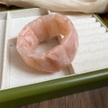 Detail of pink marble acrylic stretch bracelet inside a green velvet jewelry box - Pink