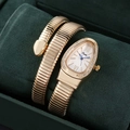 Close-up of rose gold snake bracelet watch featuring a rhinestone bezel and blue needles - Gold Color White