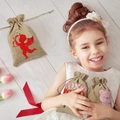 Linen drawstring Valentine gift bag with red Cupid and XOXO print held by a girl - Angel Style