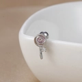 Macro shot of silver lollipop stud earring with pink swirl and zircon on a ceramic bowl - 60065-2 Silver - Lollipop