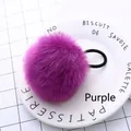 Detailed close-up of a fluffy purple faux fur pom pom hair tie on a white ceramic plate - Purple Pom Pom 5cm