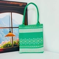 Detail of green knit tote bag featuring white geometric stripes and diamond patterns - Geometric Diamond Green