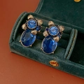 Close-up of vintage blue oval gem earrings with flower details on green velvet - 69# Silver Pin-Gold-Blue