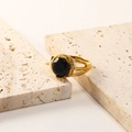 Detail of 18K gold plated titanium ring featuring a black zircon and hollow band design - US 6 / Gold Black Zirconia