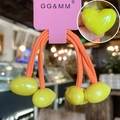 Detail of neon heart elastic hair ties in yellow and orange on pink card packaging - Yellow