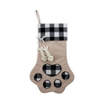Plaid dog paw Christmas stocking with hanging fish bone charms on white background - Black White Plaid Dog Paw With Fishbone Charm / Black and White Plaid