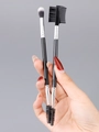 Dual-ended eyebrow brush set held by hand showing spiral spoolie and comb details - Dual-Ended Brush Set - Brow Comb & Blending (Black Silver)