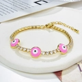 Gold evil eye bracelet with pink enamel charms and zircon stones on marble background - Gold-Pink Evil Eye