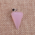 Close-up of pink crystal dowsing pendulum pendant on a textured burlap background - Pink Jade