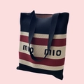 Detail of striped knitted tote bag in navy, beige, and burgundy with MIO text print - Navy Mio Stripe