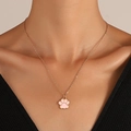 Close-up of the pink enamel cat paw pendant on a delicate gold link chain necklace - Gold/Pink