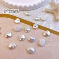 Close-up of 9x7mm baroque pearl nail charms on white tray with starfish prop - Baroque White (9*7mm)