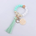 Detail of beaded keychain with mint silicone beads, MAMA wood charm, and soft tassel - Mint Green