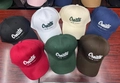 Various colors of cotton baseball caps with Create -NEW LIFE- embroidery on wooden table - Adjustable / Beige