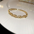 Detailed close-up of 18k gold plated U-link bracelet with sparkling pavé cubic zirconia - 22# Golden Link Buckle