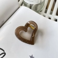 Elegant amber brown hollow heart hair claw clip made of acrylic on a white book page - Approx 4.2cm / Transparent Brown