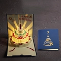 Biglietto d'auguri 3D pop-up con luci LED e torta a strati su copertina blu - Blu