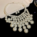 Detailed close-up of multilayer cream white pearl necklace and matching earrings on black background - Necklace-White (2-Piece Set)