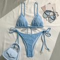 Detail of light blue bikini featuring textured fabric and elegant white pearl accents - S / Blue