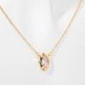 Detailed view of a gold diamond-shaped pendant necklace with a clear zircon stone - Golden Vertical Marquise