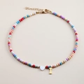 Detail of colorful beaded necklace with white heart and gold letter I pendant - Letter I
