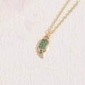 Golden necklace featuring an angel wing pendant with inlaid green cubic zirconia stones - Green Wing (14k Gold)