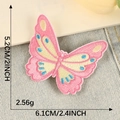 Pink and beige butterfly embroidery patch with blue dots shown on denim background - Bright Pink Butterfly