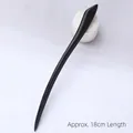 Minimalist black ebony wood hair pin 18cm length shown on white textured fabric - Narcissus