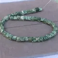 Macro shot of square green marbled natural stone beads for DIY jewelry making - Green Dot Stone