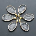 Waterdrop-shaped clear crystal pendants with gold metal edging in a flat lay display - Clear Quartz (Single)