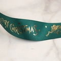 Detail of green ribbed Christmas ribbon featuring metallic gold Merry Christmas lettering - 2.5cm Bell Green / 22 Meters