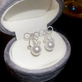 Vista macro de pendientes de lazo plateados con perla y circonita en caja de joyas - Plata (Pin de plata)