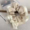 Cream waffle fabric scrunchie with elegant satin bow detail on a soft grey surface - Beige Waffle Single Bow