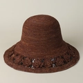 Close-up of handmade raffia sun hat featuring intricate crochet floral cutout details - M (56-58cm) / Coffee
