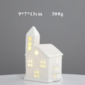 Close-up of a white ceramic house ornament with warm LED light and hollow window design - YCSQ2251 Glossy White